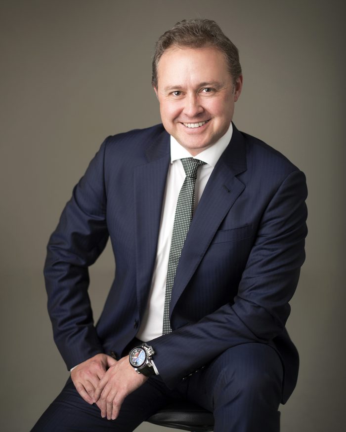 Andrei Spiegel photographed in 2015, seated, in a navy suit